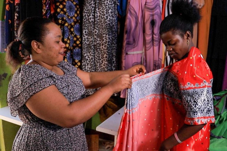 Proscovia on her workshop with a client Kiganda Cultural wear